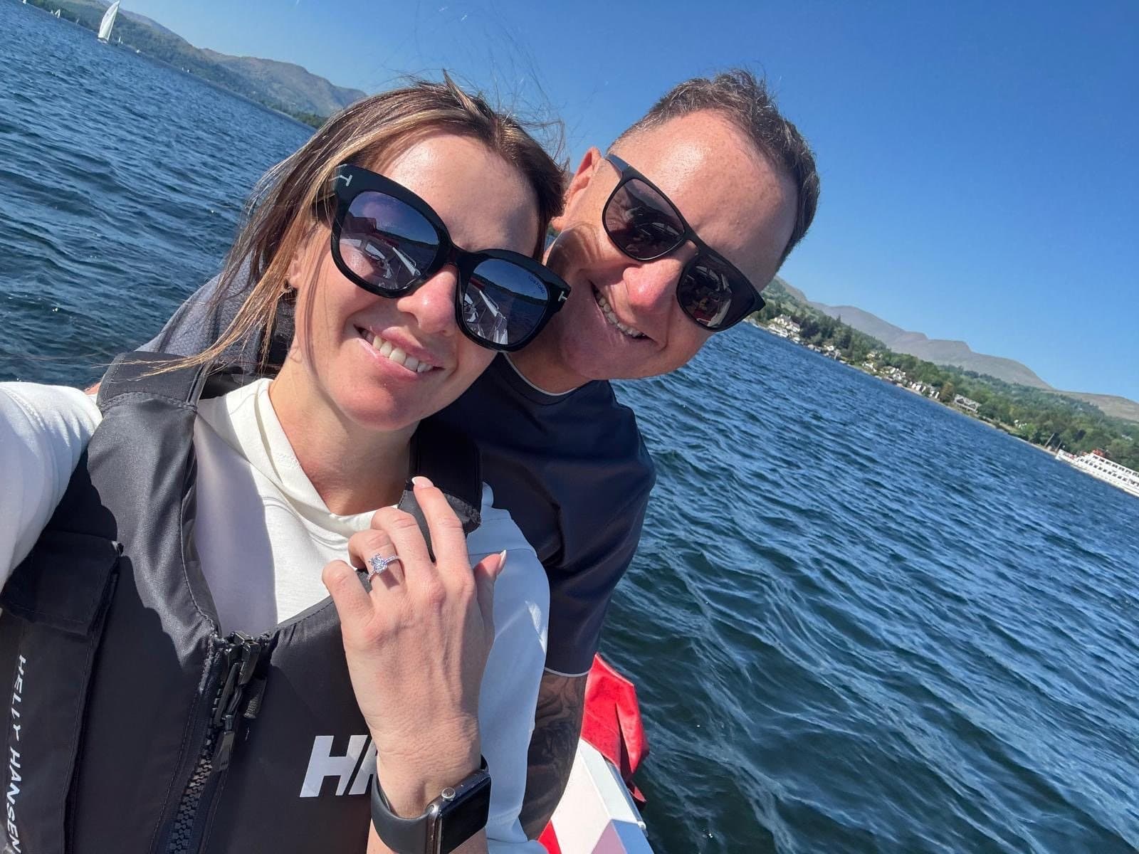Frances showing her engagement ring on a boat